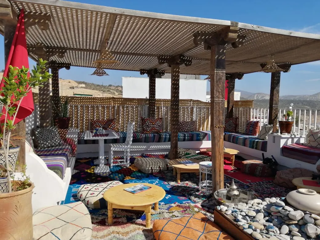 Rooftop lounge with Moroccan cushions and pergola