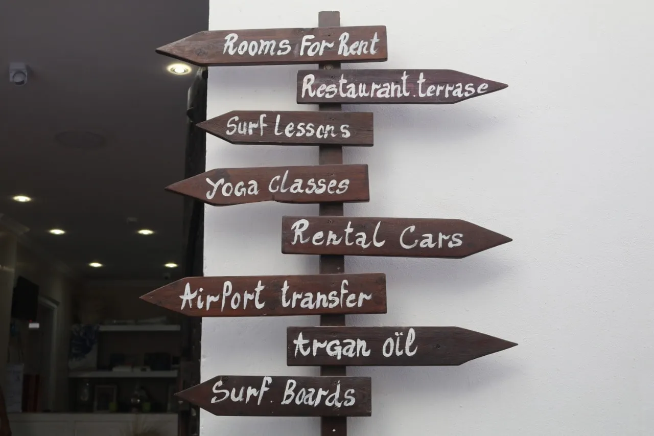 Sea Surf signpost: rooms, restaurant, surf lessons, yoga